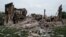 FILE - The remains of a destroyed school are pictured following a Russian military strike on the village of Bilohorivka, Luhansk region, eastern Ukraine, on May 13, 2022. Ukrainian officials say 60 people sheltering in the building's basement died in the attack.