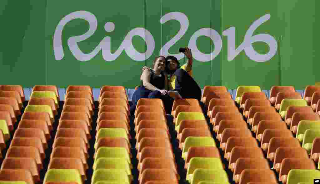 A couple takes a selfie during the women's rugby sevens match between Australia and Colombia at the Summer Olympics in Rio de Janeiro, Brazil, Aug. 6, 2016. 