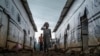 FILE - Internally displaced children walk through an alley of a camp in the town of Azezo, in Ethiopia's Amhara region, on July 12, 2021. The camp hosts Ethiopians as well as Eritrean refugees uprooted by the war in Tigray.