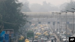 This file photo shows vehicle traffic in New Delhi, India, Tuesday, Nov. 12, 2019, as the city is covered a thick layer of smog. (AP Photo/Manish Swarup, File)