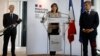 Sports Minister Amélie Oudéa-Castéra, center, speaks during a press conference with Paris police prefect Didier Lallement, left, and French Interior Minister Gerald Darmanin, May 30, 2022, in Paris. 