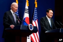 FILE - U.S. President Joe Biden, left, speaks as South Korean President Yoon Suk Yeol listens during a news conference at the People's House inside the Ministry of National Defense, May 21, 2022, in Seoul, South Korea.