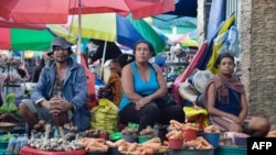 Vegetable vendors wait for customers at a traditional market in Dili on March 18, 2022, on the eve of the East Timor's presidential elections.