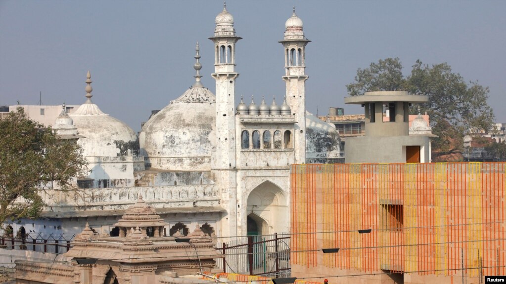 FILE - A worker stands on a temple rooftop adjacent to the Gyanvapi Mosque in the northern city of Varanasi, India, December 12, 2021. (REUTERS/Pawan Kumar/File Photo)