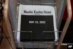 Copies of the Uvalde Leader-News with a black front page showing the date of the Robb Elementary School shooting are seen at a market in Uvalde, Texas, Thursday, May 26, 2022. (AP Photo/Jae C. Hong)
