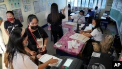 People vote during the opening of elections on May 9, 2022, in Quezon City, Philippines. About 67 million registered voters will pick a new president, with Ferdinand Marcos Jr, the son and namesake of the ousted dictator, leading pre-election surveys, and