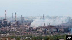 Smoke rises from the Metallurgical Combine Azovstal in Mariupol, Ukraine, May 5, 2022. Heavy fighting is raging at the besieged steel plant as Russian forces attempt to finish off the city's last-ditch defenders and complete the capture of the strategical