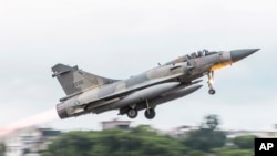 In this photo released May 27, 2022 by the Taiwan Ministry of National Defense, a French made Mirage fighter jet takes off from an airbase near Pingtung in Southern Taiwan. On Tuesday, Taiwan scrambled jets to warn away Chinese aircraft in its air defense identification zone
