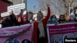 FILE: Afghan women shout slogans during a rally to protest what they say is Taliban restrictions on women, in Kabul, Afghanistan, Dec. 28, 2021.