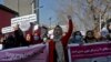 FILE - Afghan women shout slogans during a rally to protest what they say is Taliban restrictions on women, in Kabul, Afghanistan, Dec. 28, 2021.