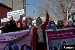 FILE: Afghan women shout slogans during a rally to protest what they say is Taliban restrictions on women, in Kabul, Afghanistan, Dec. 28, 2021.