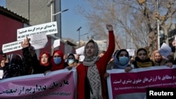 FILE - Afghan women shout slogans during a rally to protest what they say is Taliban restrictions on women, in Kabul, Afghanistan, Dec. 28, 2021.