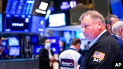 Traders work the floor at the New York Stock Exchange, in New York, May 5, 2022.