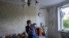 Roman Pryhodchenko cries inside his house damaged by multiple shelling in Kharkiv, Ukraine, Sunday, May 15, 2022. (AP Photo/Bernat Armangue)