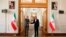 In this photo released by the Iranian Foreign Ministry, Enrique Mora, the European Union coordinator of talks to revive Iran's nuclear accord with world powers, left, shakes hands with Iran's top nuclear negotiator Ali Bagheri Kani, in Tehran, Iran, May 11, 2022.