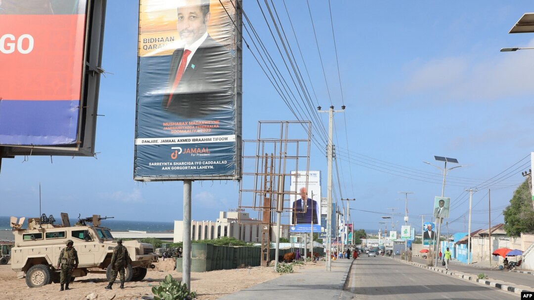 African Union peacekeepers stand next to election banners of presidential candidates along a street in Mogadishu, Somalia, May 13, 2022.
