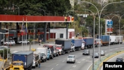 Camiones de remolque se alinean a lo largo de una avenida para llenar sus tanques en una estación de servicio como parte de una creciente escasez de diésel, en Caracas, el 5 de marzo de 2021.