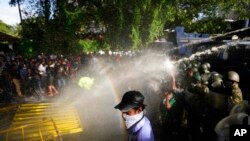 Police fire tear gas and water cannons to disperse protesting members of the Inter University Students Federation during an anti-government protest in Colombo, Sri Lanka, May 19, 2022.