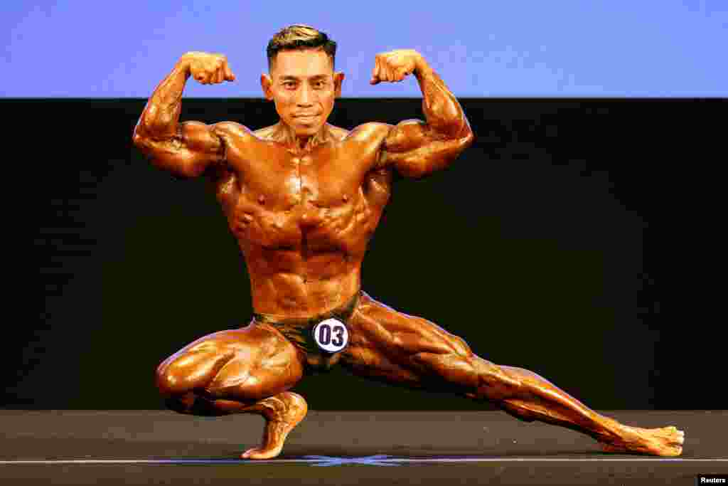 Vietnam's Mach Pham Van poses during the Men Bodybuilding 55kg competition, during the Southeast Asian Games, at Hanoi Sports Training and Competition Center, Hanoi, Vietnam.