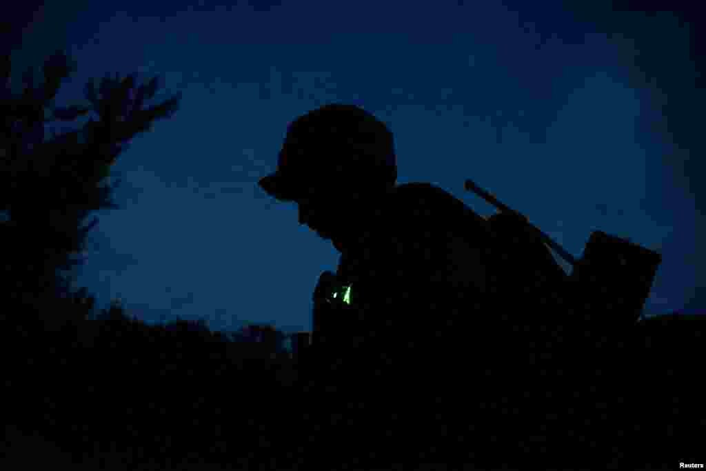 A Ukrainian serviceman patrols an area, as Russia's attack on Ukraine continues, in an undisclosed location in Kharkiv region, Ukraine.
