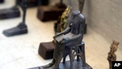 A Headless Bronze Statue Of Pharaoh Djoser'S Chief Architect Imhotep, Who Oversees The Building Of The Step Pyramid, Is On Display At A Temporary Exhibition At The Steps Of The Step Pyramid In Saqqara, Near Cairo, Egypt, May 30, 2022.