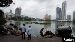 Vehicles of Sri Lanka's ruling party supporters are seen in a lake after being pushed into the water during a clash of pro and anti-government demonstrators, in Colombo, Sri Lanka, May 10, 2022. 