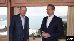 This handout photo taken and released on March 13, 2022 by the Turkish presidential press service shows Turkish President Recep Tayyip Erdogan, left, meets with Greek Prime Minister Kyriakos Mitsotakis in Istanbul. 
