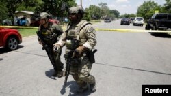 Law enforcement personnel near the scene of a suspected shooting near Robb Elementary School in Uvalde, Texas, May 24, 2022.