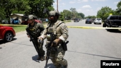 Law enforcement personnel near the scene of a suspected shooting near Robb Elementary School in Uvalde, Texas, May 24, 2022.