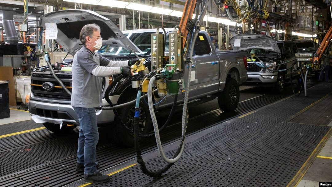 FILE - A Ford Motors assembly worker works on a Ford F-series pickup truck at the Dearborn Truck Plant in Dearborn, Michigan, Jan. 26, 2022. 