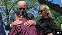 US President Joe Biden embraces Mandy Gutierrez, the principal of Robb Elementary School, as he and First Lady Jill Biden pay their in Uvalde, Texas, May 29, 2022.