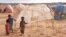 FILE - Children stand next to a makeshift shelter at the Higlo camp for people displaced by drought, in the town of Gode, in Ethiopia's Somali region, April 27, 2022. 