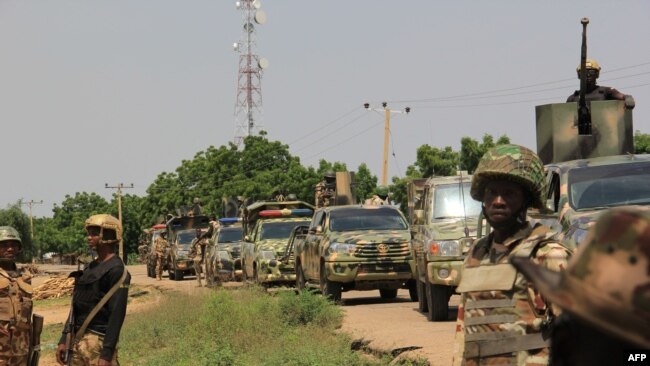FILE - Nigerian soldiers patrol on Oct. 12, 2019, after gunmen suspected of belonging to the Islamic State West Africa group raided the village of Tungushe, killing a soldier and three residents.