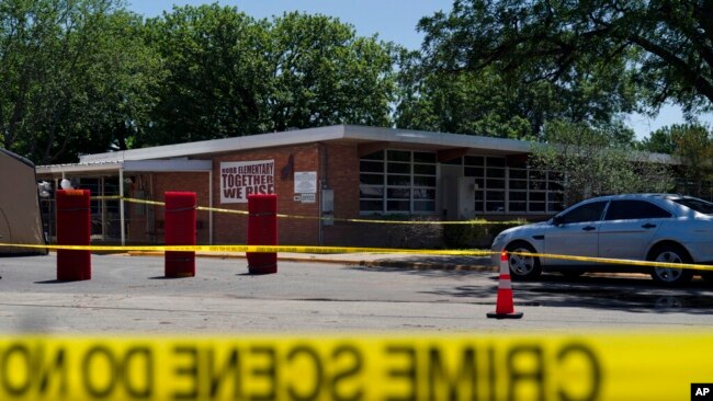 Crime scene tape surrounds Robb Elementary School in Uvalde, Texas, May 25, 2022, site of a mass shooting that occurred the day before. At least 19 fourth-graders and their two teachers were killed.