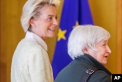 US Treasury Secretary Janet Yellen, right, is welcomed by President of the EU Commission Ursula von der Leyen in Brussels, May 17, 2022