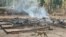 This photo from humanitarian group Free Burma Rangers taken May 3, 2022, and released May 4 shows a dog running past the burning remains of a building after airstrikes and mortar attacks by the Myanmar military, according to the Free Burma Rangers.