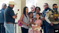 Guests leave Sacred Heart Catholic Church following the joint funeral service for Irma Garcia and husband Joe Garcia, June 1, 2022, in Uvalde, Texas. Irma Garcia was killed in last week's elementary school shooting; Joe Garcia died two days later. 