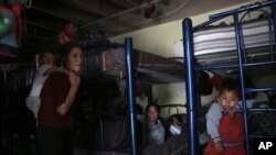 FILE - Migrants rest in a dormitory of the Good Samaritan shelter in Juarez, Mexico, March 29, 2022. 