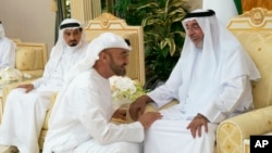 FILE - Sheikh Khalifa bin Zayed Al Nahyan, the president of the United Arab Emirates and ruler of Abu Dhabi, right, is greeted by Sheikh Mohammed bin Zayed Al Nahyan, the crown prince of Abu Dhabi, center, at Al Bateen Palace in Abu Dhabi, United Arab Emirates, May 8, 2019.