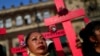 Mujeres sostienen cruces en una protesta contra el feminicidio y la violencia contra las mujeres frente al Palacio Nacional en la Ciudad de México.&nbsp;