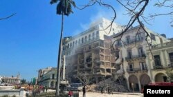 La explosión ocurrió alrededor de las 10:50 de la mañana de este viernes. La fotografías muestran daños en el edificio de viviendas situado en un lateral del hotel. [Foto: Reuters].