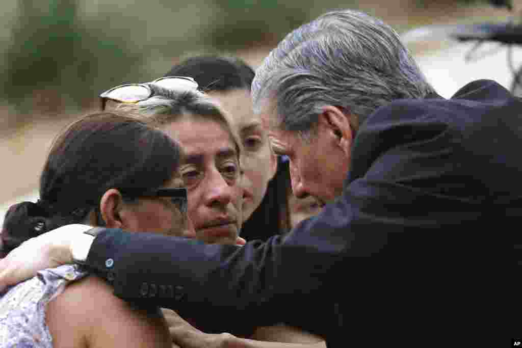 The archbishop of San Antonio, Gustavo Garcia-Siller, comforts families outside the Civic Center following a deadly school shooting at Robb Elementary School in Uvalde, Texas, May 24, 2022.