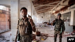 FILE: Residents of Lalibela, Ethiopia endured the occupation by the Tigray People's Liberation Front (TPLF) insurgent group. Here, militia fighters walk through what is left of the Lalibela airport terminal, December 7, 2021. 