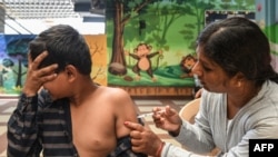 A health worker inoculates a school student during a vaccination drive held for children age 12-14, as a preventive measure against Covid-19 coronavirus at a school in Bangalore, India, May 9, 2022.