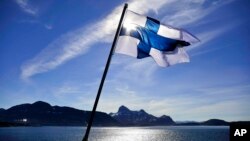 FILE - Finland's flag flutters aboard an icebreaker in 2017.