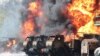 FILE - Vehicles on fire at an oil depot after missiles hit the facility in an area controlled by Russian-backed separatist forces in Makiivka, 15 km (94 miles) east of Donetsk, eastern Ukraine, on May 4, 2022.