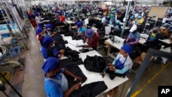 FILE - Workers tend to their jobs in a garment factory in Maseru, Lesotho, Feb. 24, 2022. The coronavirus pandemic impacted the global fashion industry and the tens of millions of workers, most of them women, who stitched the world's clothes. 