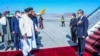FILE - This handout photo released by the Taliban Foreign Ministry shows Taliban Foreign Minister Amir Khan Muttaqi, left, greeting China's Foreign Minister Wang Yi upon his arrival at the Kabul airport on March 24, 2022. 