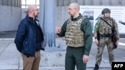 A handout picture, taken and released by Ukrainian Prime Minister Press Service on May 9, 2022, shows European Council President Charles Michel (left) listening to Ukraine's Prime Minister Denys Shmyhal during their meeting in the southern Ukrainian port.