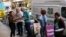 Campaign volunteers address a voter at the entrance to an Australian Electoral Commission early voting center ahead of the national election, in the Central Business District of Sydney, May 17, 2022. 